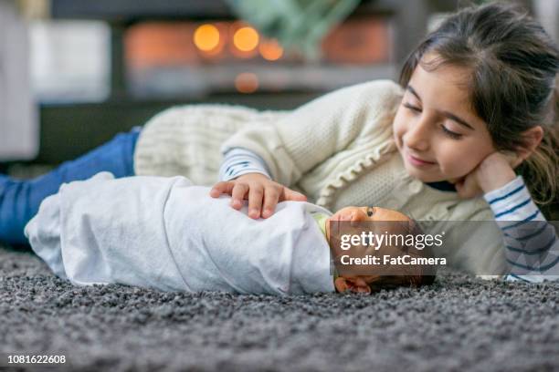 little girl admiring her new brother - baby blanket stock pictures, royalty-free photos & images