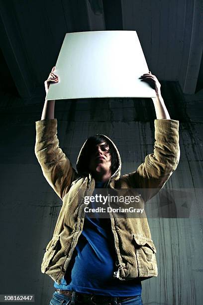 trendy young man holding up blank white sign - person holding up sign bildbanksfoton och bilder