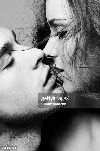 portrait of young couple about to kiss, black and white - alluring stock pictures, royalty-free photos & images