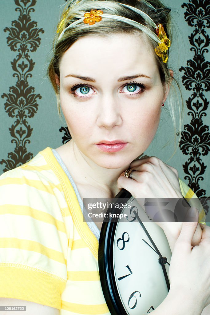 Young Woman Holding Clock