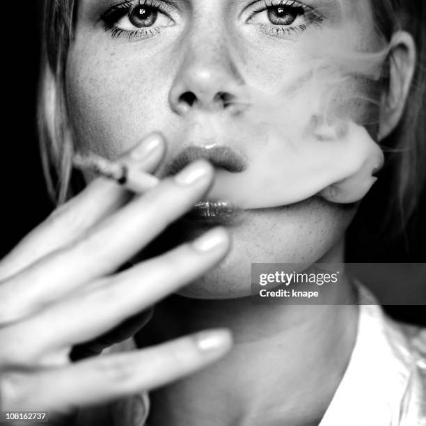 young woman smoking cigarette, black and white - beautiful women smoking cigarettes stock pictures, royalty-free photos & images