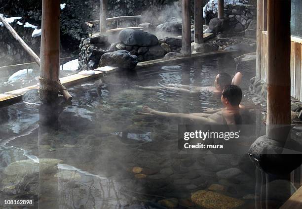 two naked men relaxing in hot japanese dos - hot spring stock pictures, royalty-free photos & images