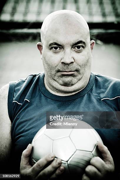bald man holding soccer ball - fat soccer players stock pictures, royalty-free photos & images