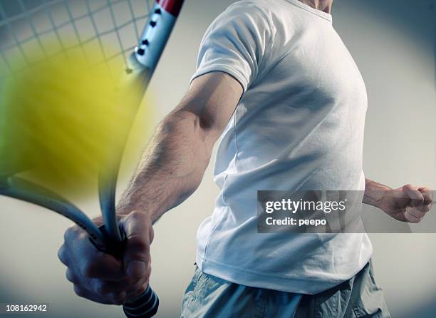 person hitting yellow ball with tennis racquet - tennis quick stock pictures, royalty-free photos & images