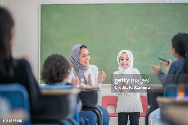 applauding presentation - islamic school stock pictures, royalty-free photos & images