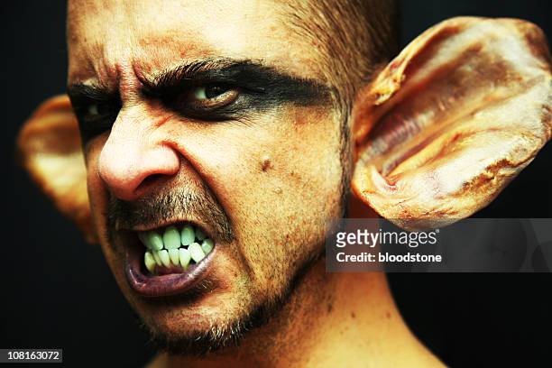 portrait of goblin man with pigs ears - goblin stock pictures, royalty-free photos & images