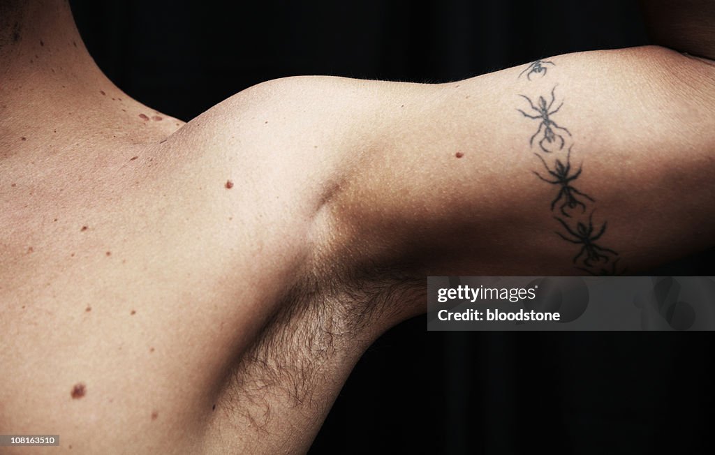 Man Flexing Arm Muscle With Tattoo High-Res Stock Photo - Getty Images