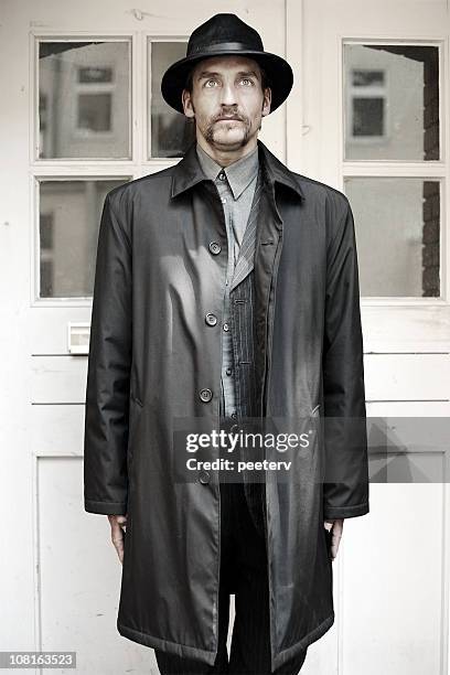 man in trench coat and hat - man coat stock pictures, royalty-free photos & images