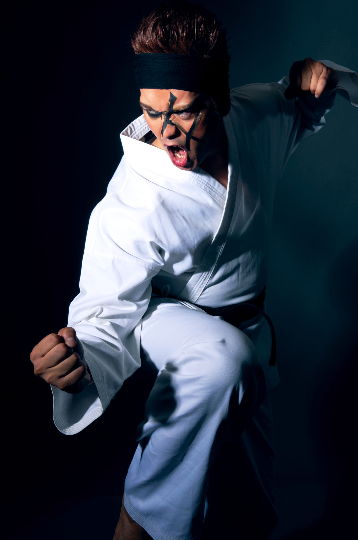 Man Wearing Karate Gi and Face Paint Posing Man Wearing Karate Gi and Face Paint Posing