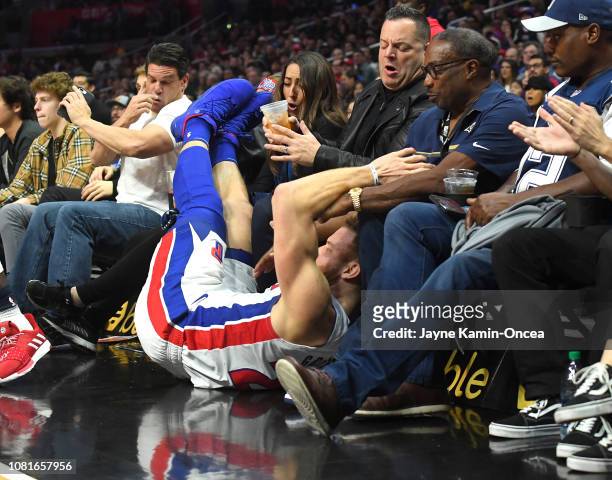 Blake Griffin of the Detroit Pistons crashes into the seats after diving for a loose ball in the second half of the game against the Los Angeles...