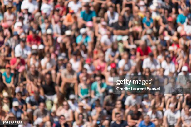 full frame blurred shot of crowd sitting in a stadium - creative crowd imagens e fotografias de stock