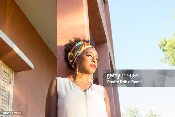 woman standing on a column of an abandoned house - showus africa stock pictures, royalty-free photos & images