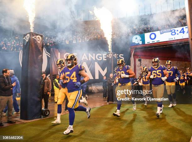 Los Angeles Rams run onto the field ahead of the NFC Divisional Round playoff game against the Dallas Cowboys at Los Angeles Memorial Coliseum on...