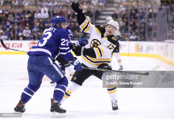 Toronto Maple Leafs defenseman Travis Dermott checks Boston Bruins center Ryan Donato as the Toronto Maple Leafs play the Boston Bruins at Scotiabank...