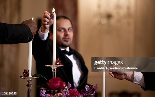 Staff light candles before a luncheon at the US State Department 19, 2011 in Washington, DC. Secretary of State Hillary Rodham Clinton and Vice...