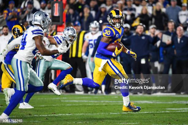 Running back Todd Gurley of the Los Angeles Rams rushes for a touchdown in the second quarter against the Dallas Cowboys to take a 20-7 in the NFC...