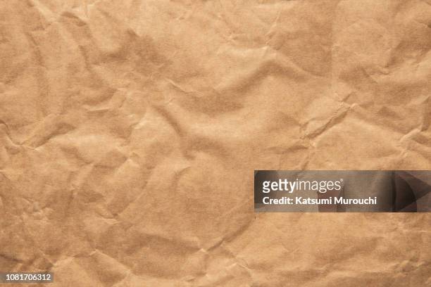 wrinkled brown paper texture background - kraft paper stock pictures, royalty-free photos & images