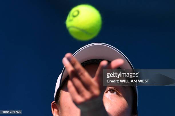 China's Peng Shuai serves the ball during a practice session ahead of the Australian Open tennis tournament in Melbourne on January 13, 2019. - IMAGE...