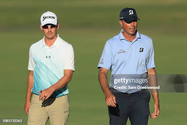 Andrew Putnam and Matt Kuchar of the United States walk on the 18th hole during the third round of the Sony Open In Hawaii at Waialae Country Club on...