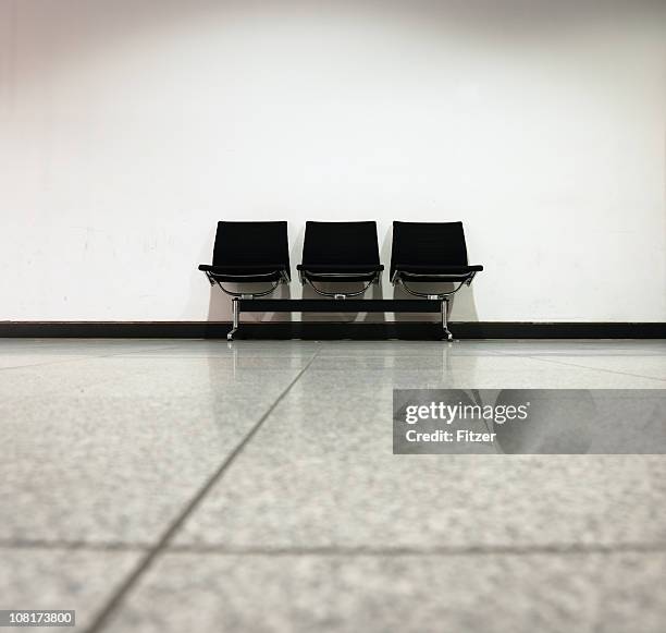 lone bench against wall, black and white - eames chair stock pictures, royalty-free photos & images
