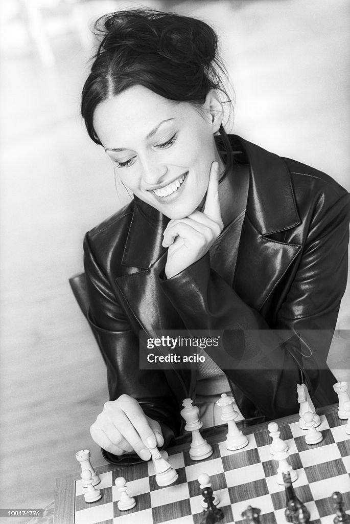 Black and White Portrait of Young Woman Playing Chess