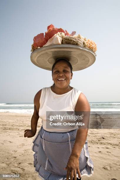 woman with tray of shells on head at beach - acapulco shore bildbanksfoton och bilder