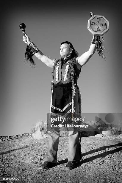 native american man holding drum in air - warrior chief stock pictures, royalty-free photos & images