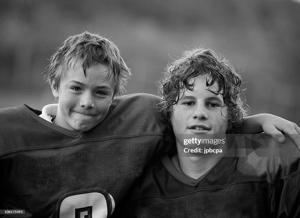 Two Boys Wearing Football Jerseys