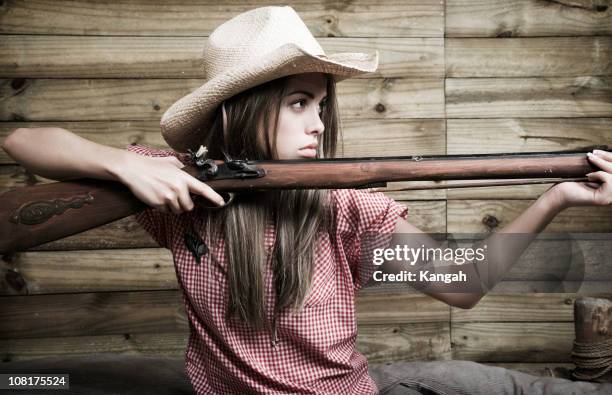 cowgirl woman holding rifle - retro cowgirl stock pictures, royalty-free photos & images