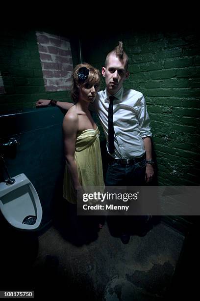 urban couple standing in grungy washroom - nightclub bathroom stockfoto's en -beelden