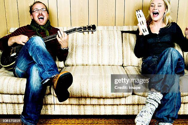 funny couple playing music - duet stockfoto's en -beelden