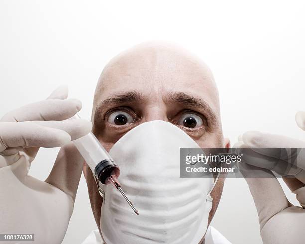 portrait of dentist holding surgeon and dental pick - funny surgical masks stock pictures, royalty-free photos & images