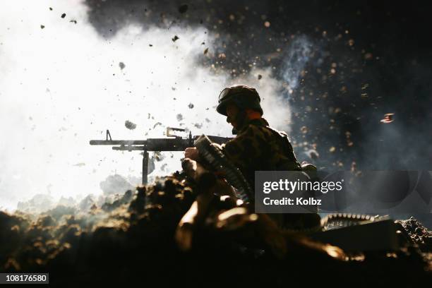 toy soldier gunner in front of explosion - toy soldier stock pictures, royalty-free photos & images