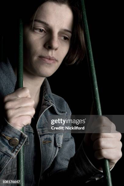 triste joven mujer agarrando hasta bares de sujeción - anemia fotografías e imágenes de stock