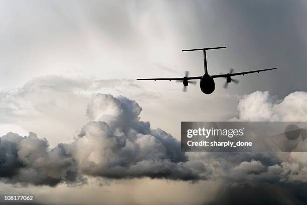 propeller airplane flying in storm - small plane storm stock pictures, royalty-free photos & images