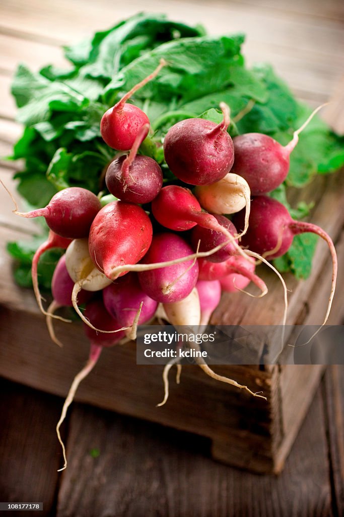 Bunch of radish on a an old wooden board