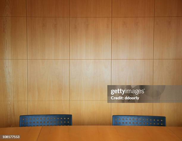 office boardroom with two chairs and table - wooden wall stockfoto's en -beelden