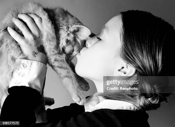 litte girl holding her kitty - black and white cat stock pictures, royalty-free photos & images