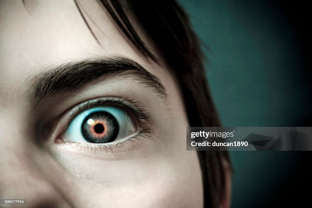Close-up of Little Boy's Eye with Red Pupil
