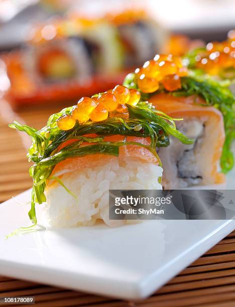 huge veggie maki sushi on white plate - square plate stock pictures, royalty-free photos & images