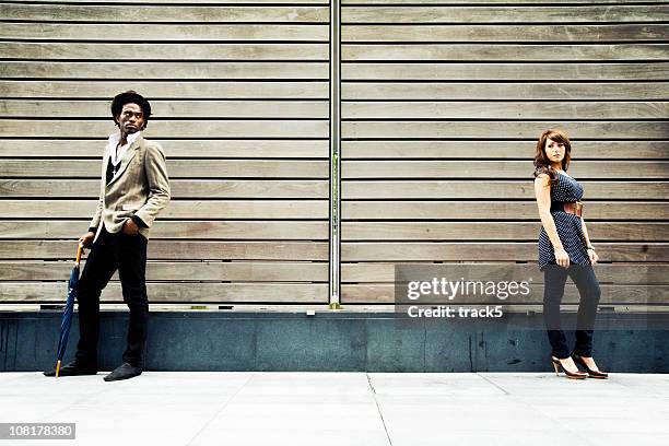 man and woman facing away from each other - standing apart stock pictures, royalty-free photos & images