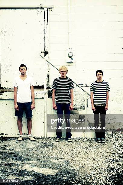 three teenage boys standing against urban wall - only teenage boys stock pictures, royalty-free photos & images
