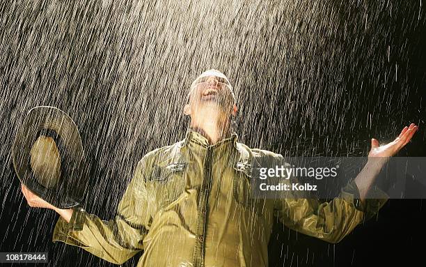 farmer in the rain - saturated color stock pictures, royalty-free photos & images