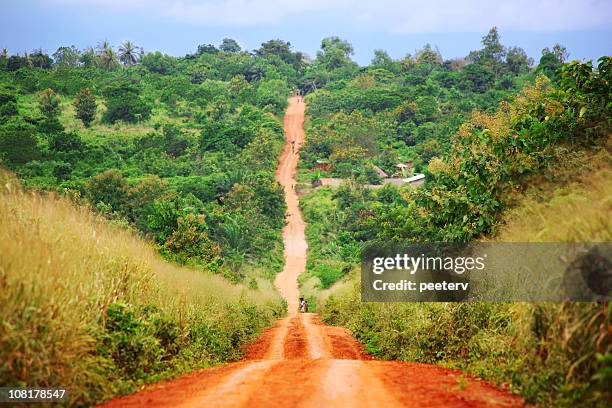 rural red dirt road in african countryside - benin stock pictures, royalty-free photos & images