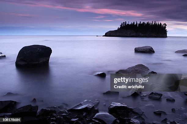 lake superior shoreline and island at sunset - lake superior stock pictures, royalty-free photos & images