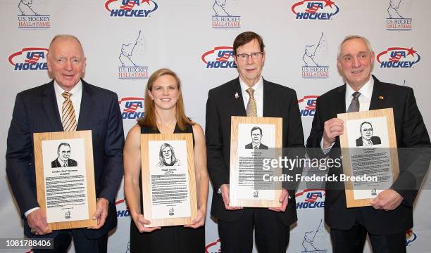 Gordon "Red" Berenson, Natalie Darwitz, David Poile, and Paul Stewart pose with their Hall of Fame plaques at the U.S. Hockey Hall Of Fame Induction...