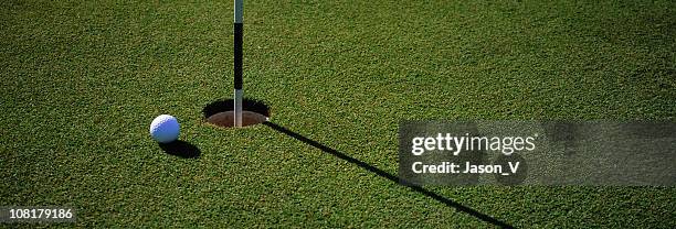golf ball near hole - golf panoramic stock pictures, royalty-free photos & images