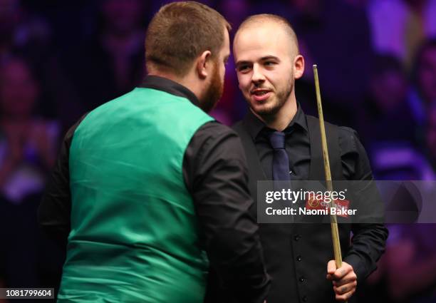 Mark Allen of Northern Ireland shakes hands with Luca Brecel of Belgium and Luca Brecel wins the first round match during day one of The Dafabet...