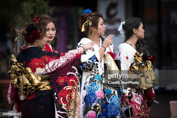 Japanese new adults wearing kimonos smokes cigarettes during the Coming of Age Day celebration in Chatan, Okinawa City, Japan on January 13, 2019....