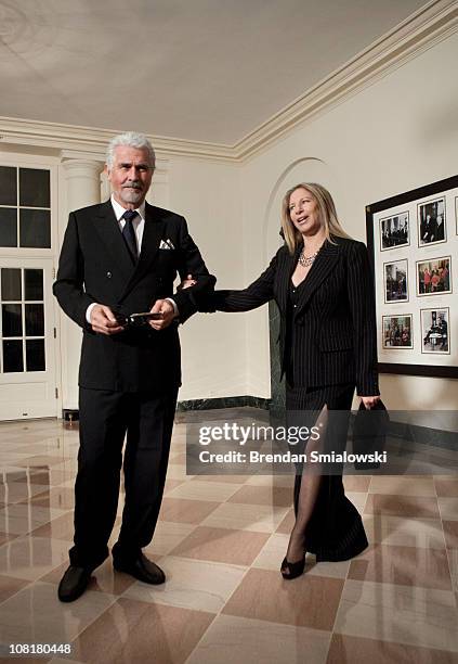 Singer Barbra Streisand pulls on her husband actor James Brolin's arm while arriving at the White House for a state dinner 19, 2011 in Washington,...